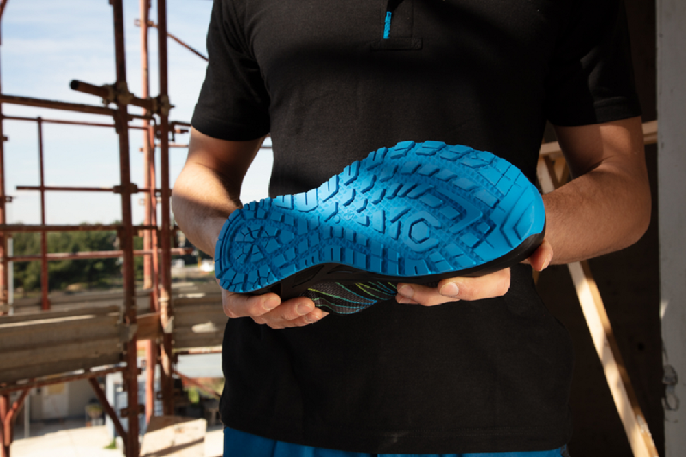 A person holding a blue shoe